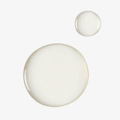 Close-up of clear serum drops, skincare product texture on white background