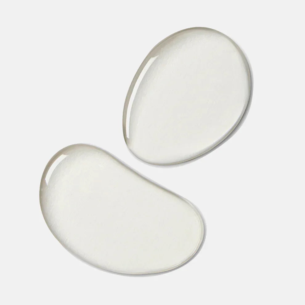 Clear toner liquid drops on a white background, skincare product texture