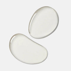 Clear toner liquid drops on a white background, skincare product texture