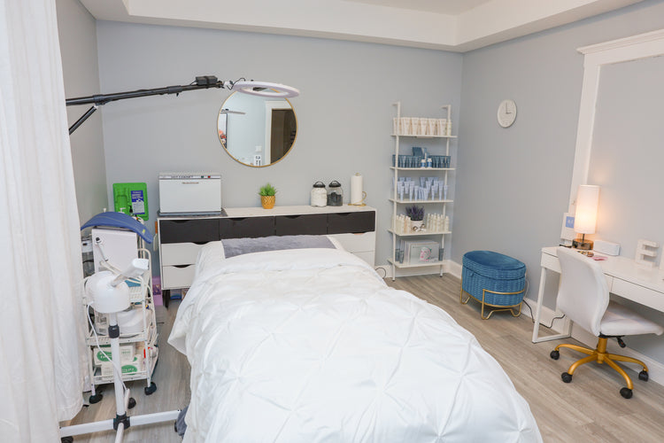 Acne clinic room with bed, medical equipment, office desk, and esthetician skin care recommendations.