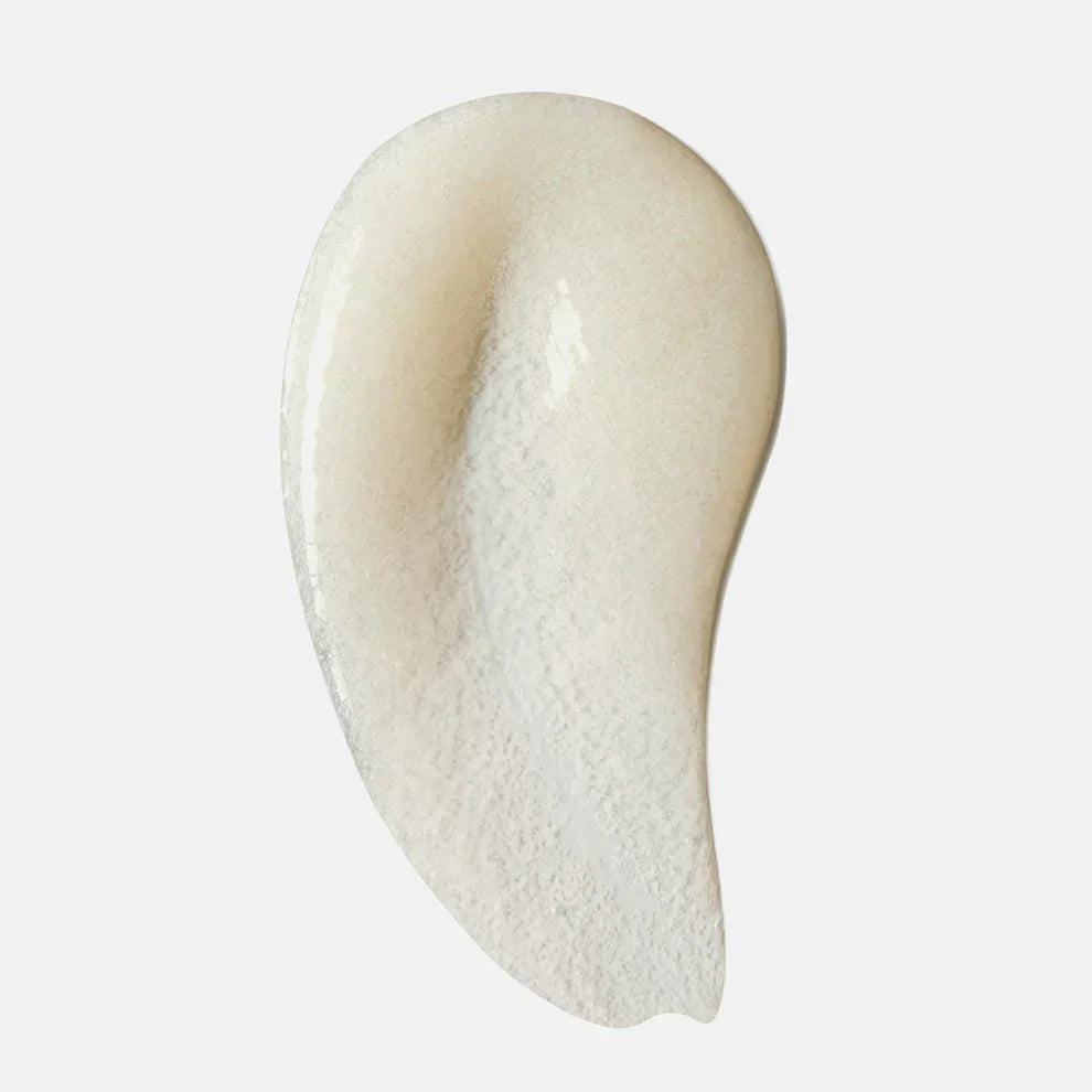 Creamy exfoliating face scrub texture smear on white background, skincare product