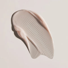 Pink skincare tool on a light pink background