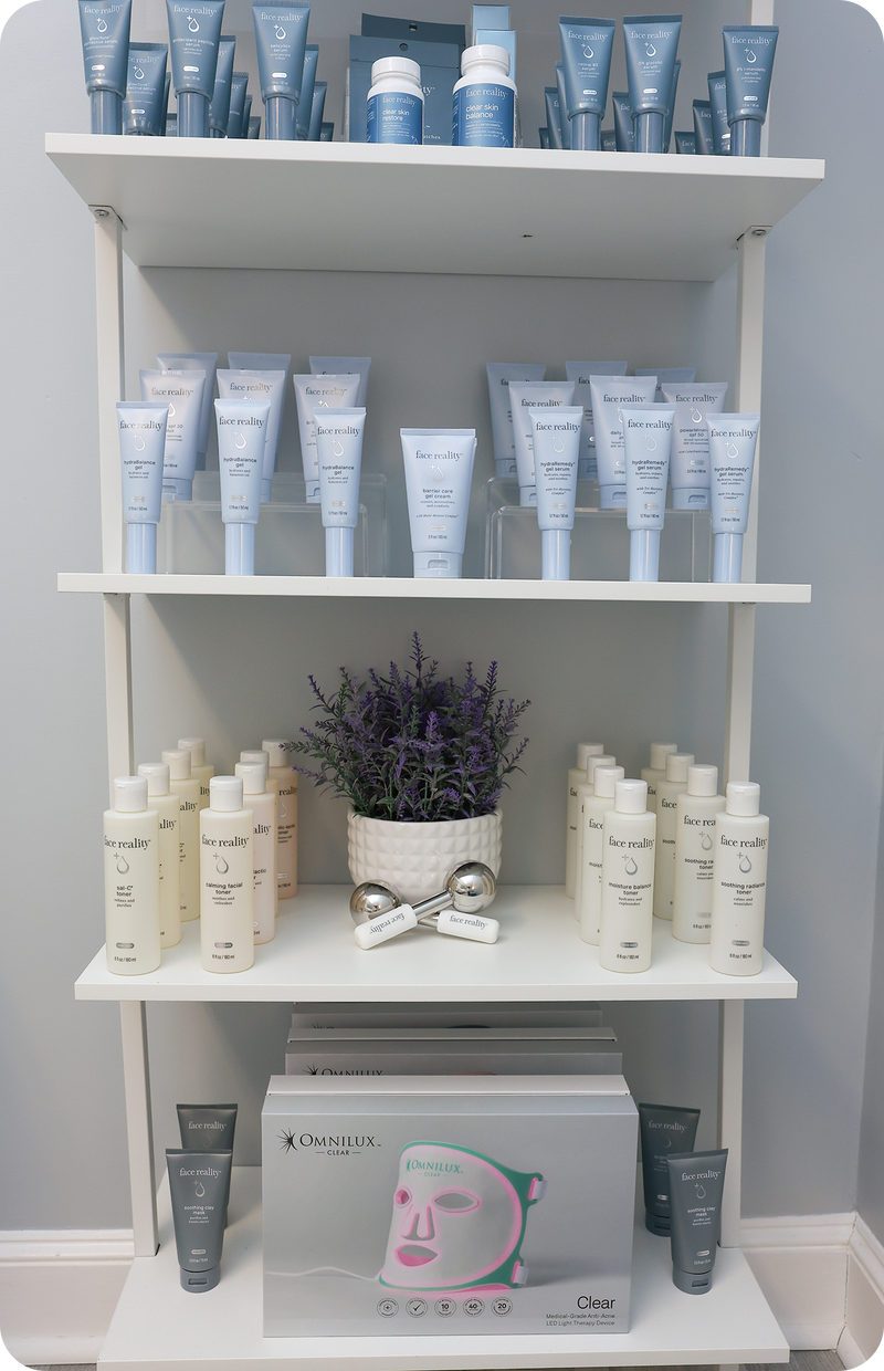 Shelving unit with skincare products and a plant on a gray wall background