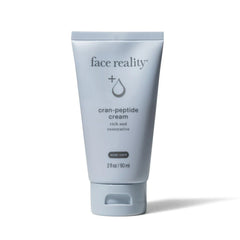 Tube of 'face reality' cran-peptide cream on a white background