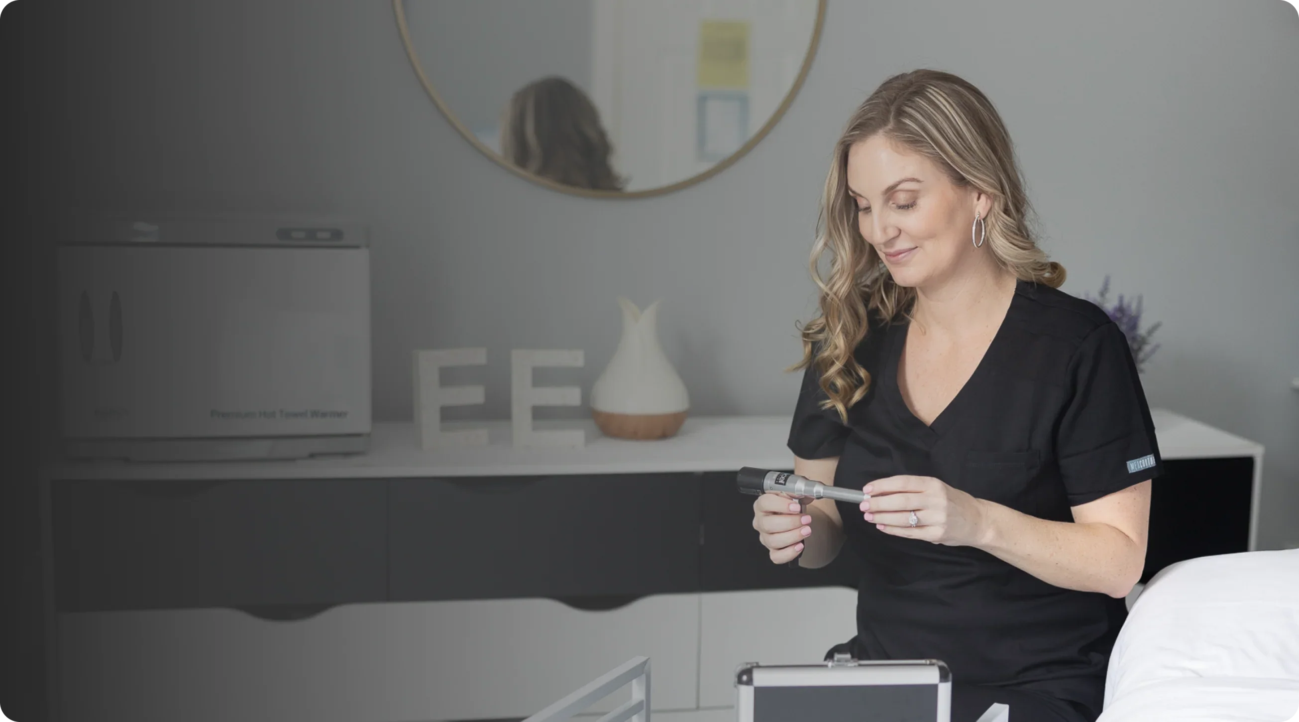 Esthetician preparing skincare treatment in a modern facial spa room